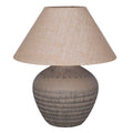 Unlit table lamp with a rounded brown etched ceramic base and wide tapered woven shade on a white background.