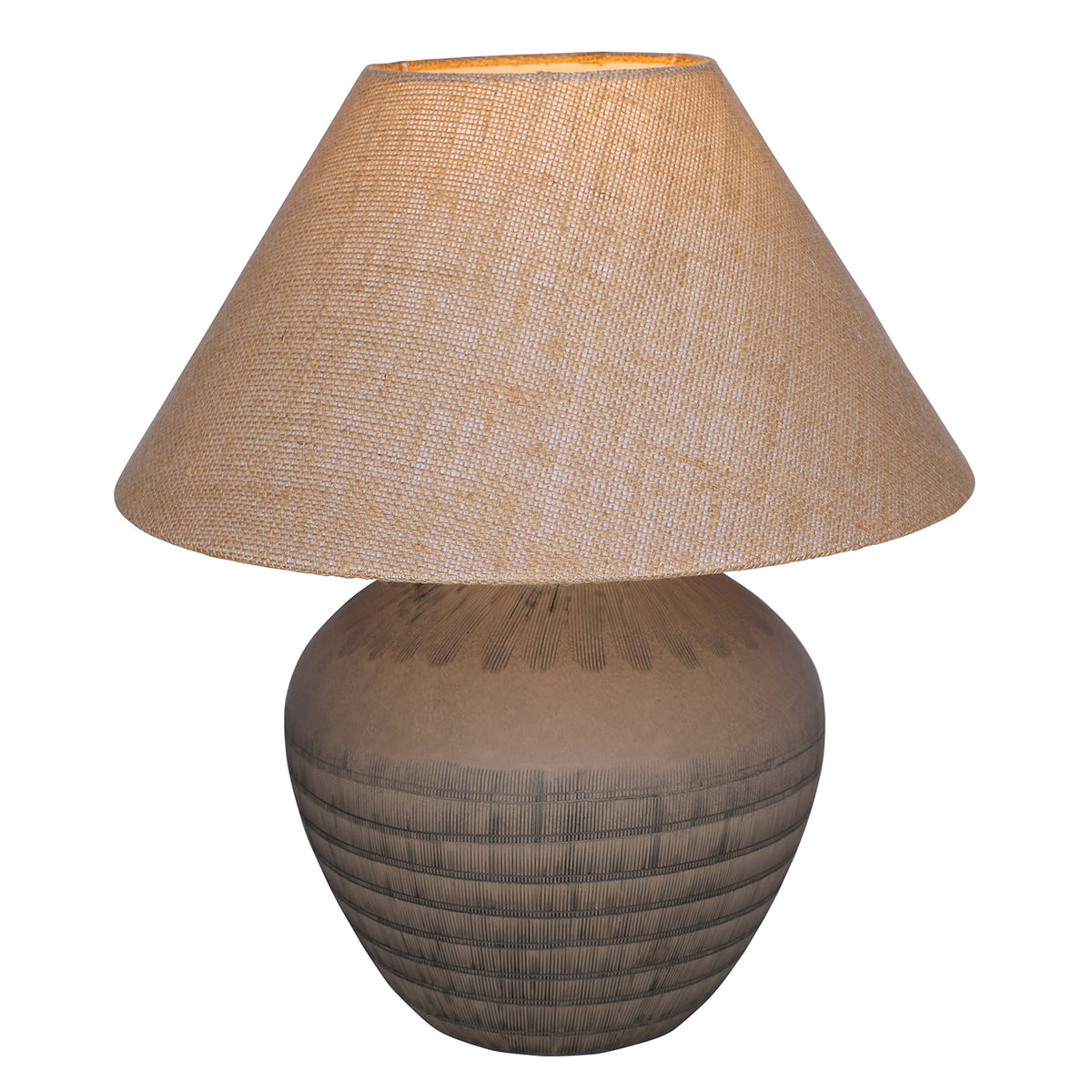 Brown ceramic table lamp switched on, with warm light glowing through the tapered hessian shade.