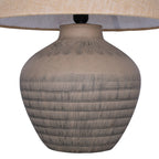 Close view of the rounded ceramic base, showing etched horizontal bands and fine lines beneath the shade.