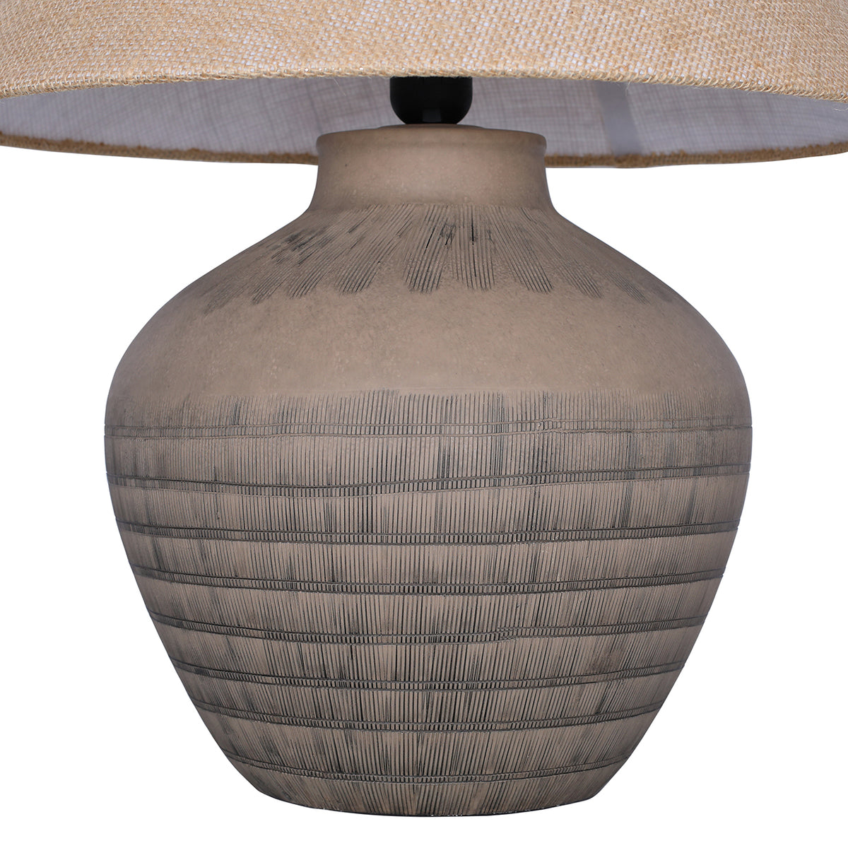 Close view of the rounded ceramic base, showing etched horizontal bands and fine lines beneath the shade.