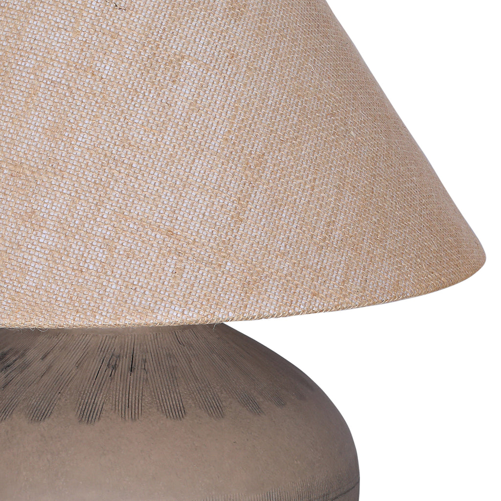 Detail of the hessian shade's open weave above the brown ceramic shoulder with radiating etched lines.