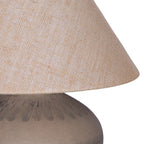 Detail of the hessian shade's open weave above the brown ceramic shoulder with radiating etched lines.