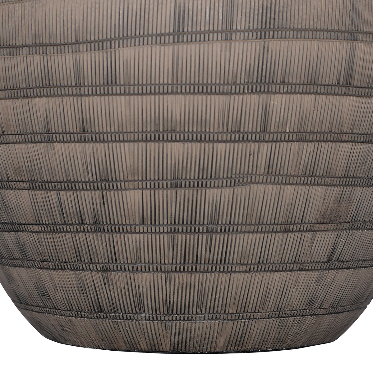 Close-up of the lower brown ceramic base, with narrow horizontal bands crossing closely spaced vertical etched lines.