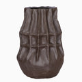 Front view of a deep brown vase with stacked angular facets, vertical grooves and a rounded base.