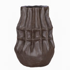 Front view of a deep brown vase with stacked angular facets, vertical grooves and a rounded base.