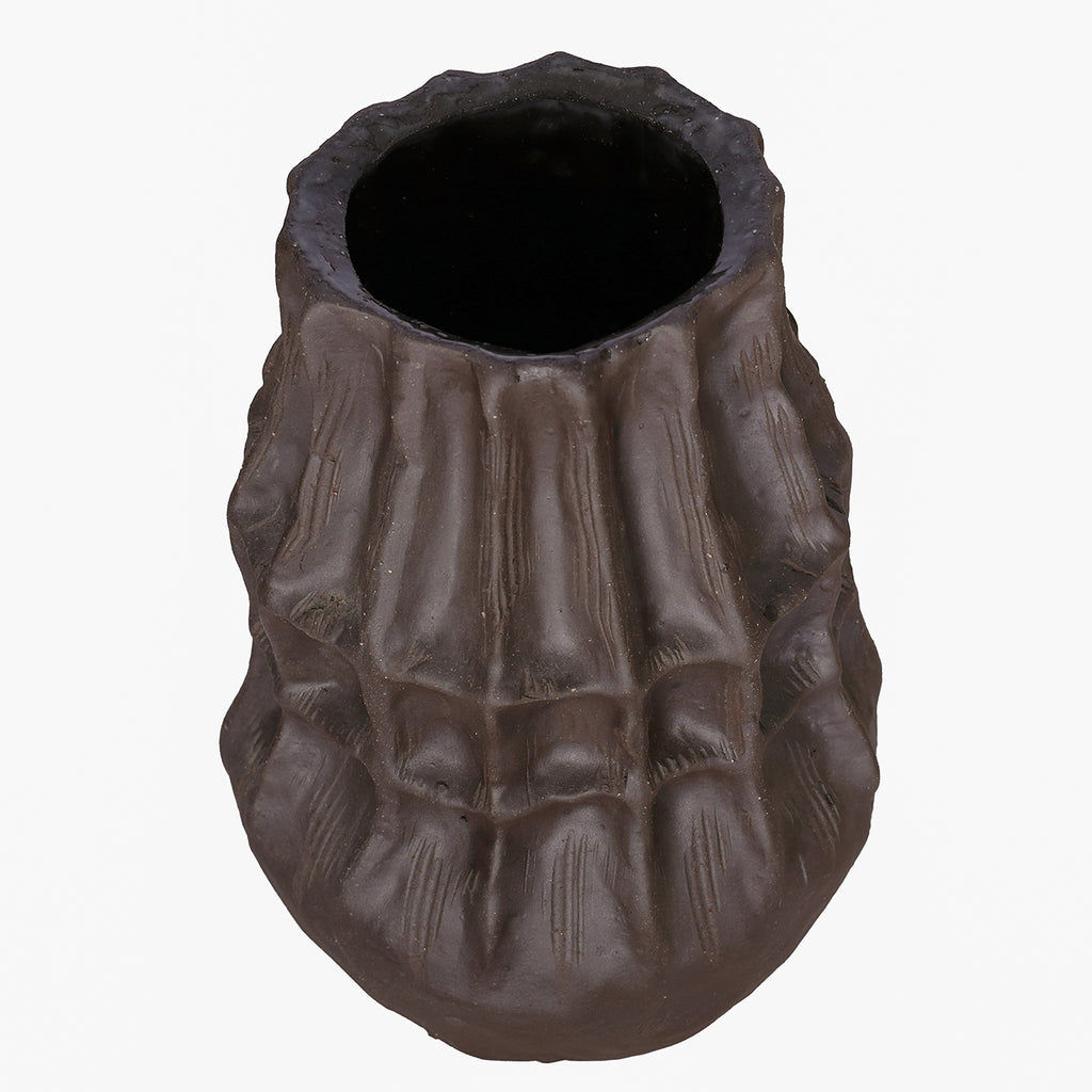 Brown faceted vase viewed from above at an angle, showing its open mouth and textured sides.