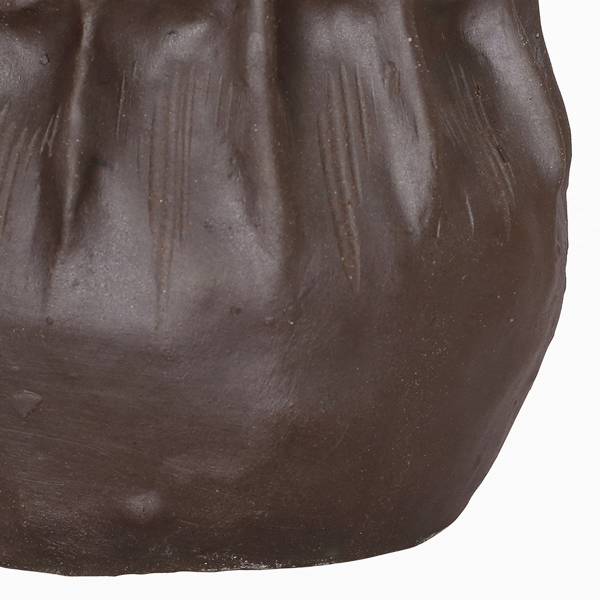 Detail of the vase's lower body, showing fine grooves, angular contours and the brown matte surface.