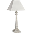 Faceted Rise Table Lamp with a pale tapered square shade, slender faceted stem and stepped square foot on a white background.