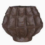 Front view of a rounded brown vase with irregular facets, scored surface detail and a narrow base against white.