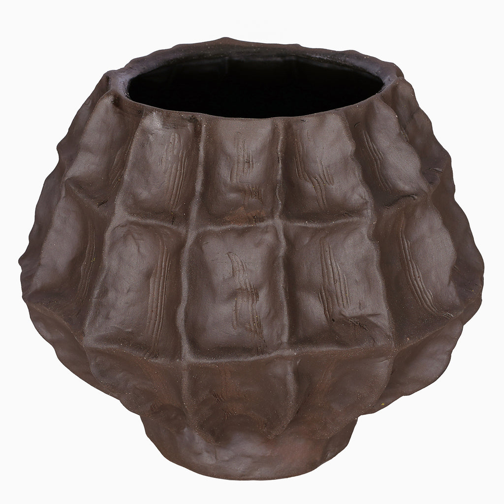 Angled view of the faceted brown vase showing its wide opening, dark interior and curved body.