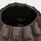 View down into the vase's dark interior, showing the uneven brown rim and textured upper facets.