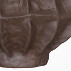 Close-up of the lower facets and narrow base, showing the vase's matte brown textured surface.