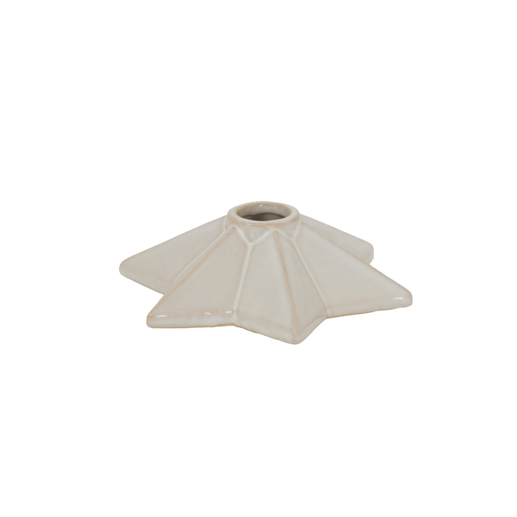 Low angled view of the cream star candle holder, showing the raised central socket and sloping faceted points.