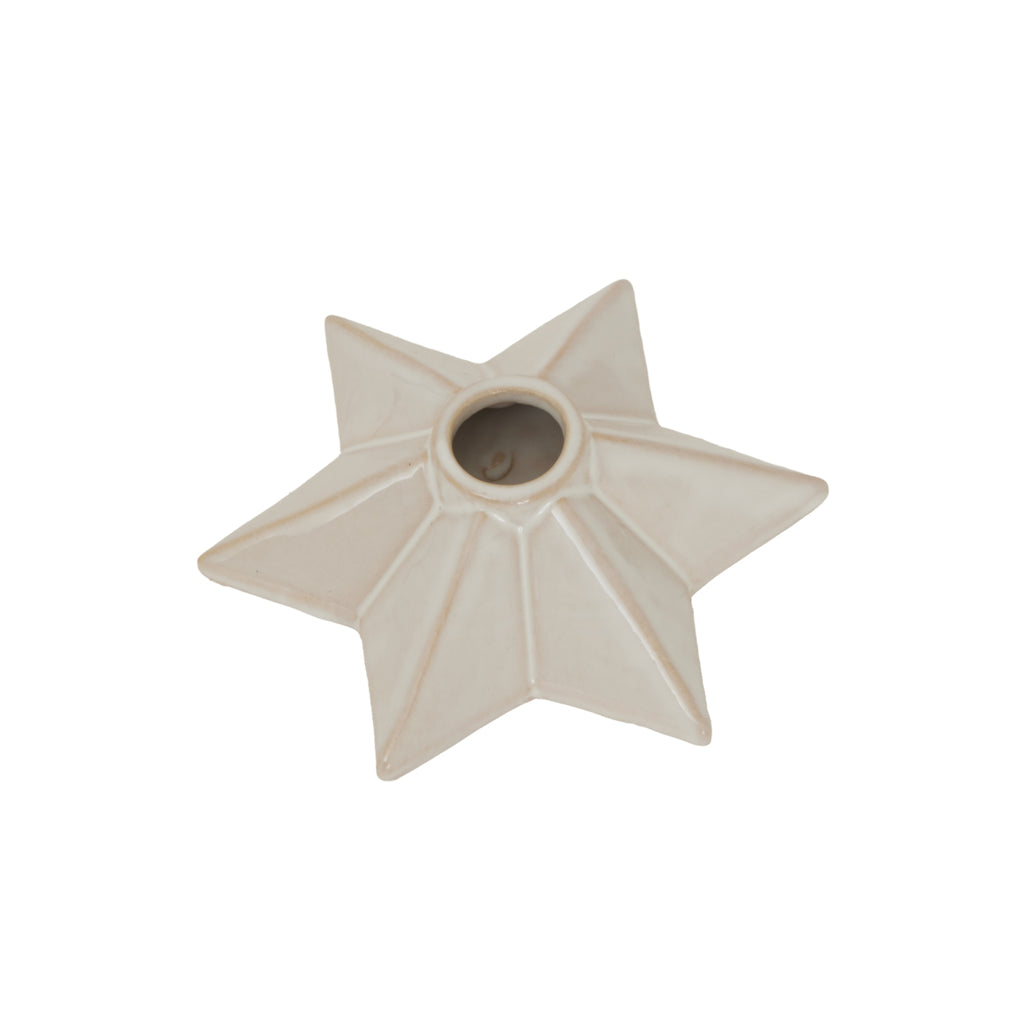 Cream faceted star candle holder viewed from above at an angle on a white background, showing its full outline and empty socket.