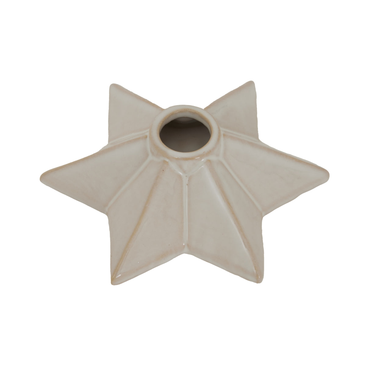 Close angled view into the candle holder's central opening, with warm cream shading along the star's raised ridges.