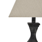 Close view of the shade's pale woven texture above the dark neck, stepped collar and narrow faceted waist.