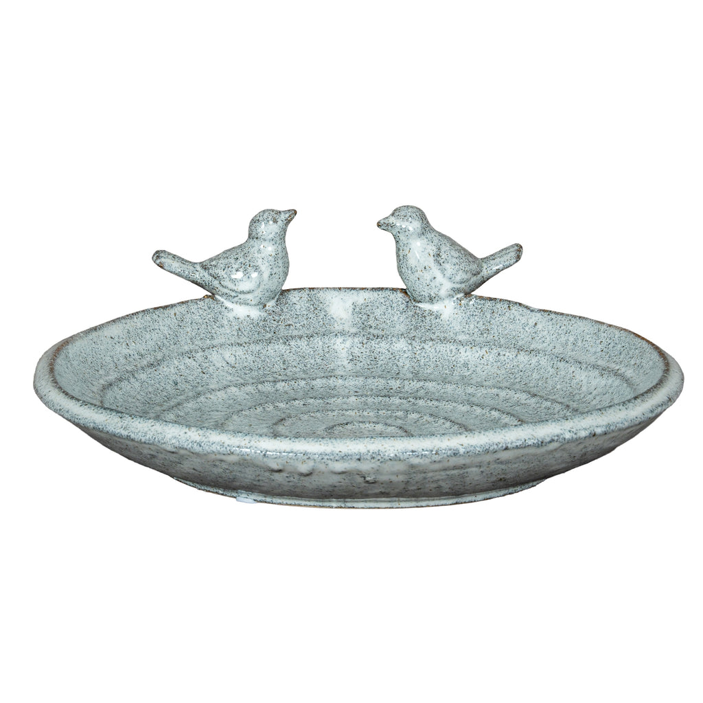 Full view of a shallow speckled bird bath with a rounded rim, low foot and two sculpted birds facing each other at the back.