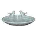 Full view of a shallow speckled bird bath with a rounded rim, low foot and two sculpted birds facing each other at the back.