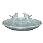 Full view of a shallow speckled bird bath with a rounded rim, low foot and two sculpted birds facing each other at the back.