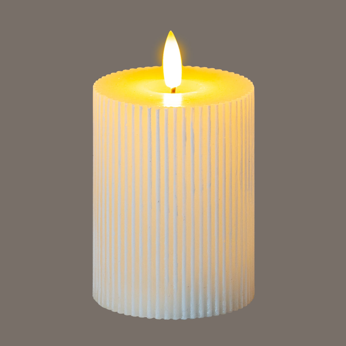 Ribbed LED candle against a grey background, pictured with a bright yellow-white flame-shaped top and yellow light across the recessed rim.
