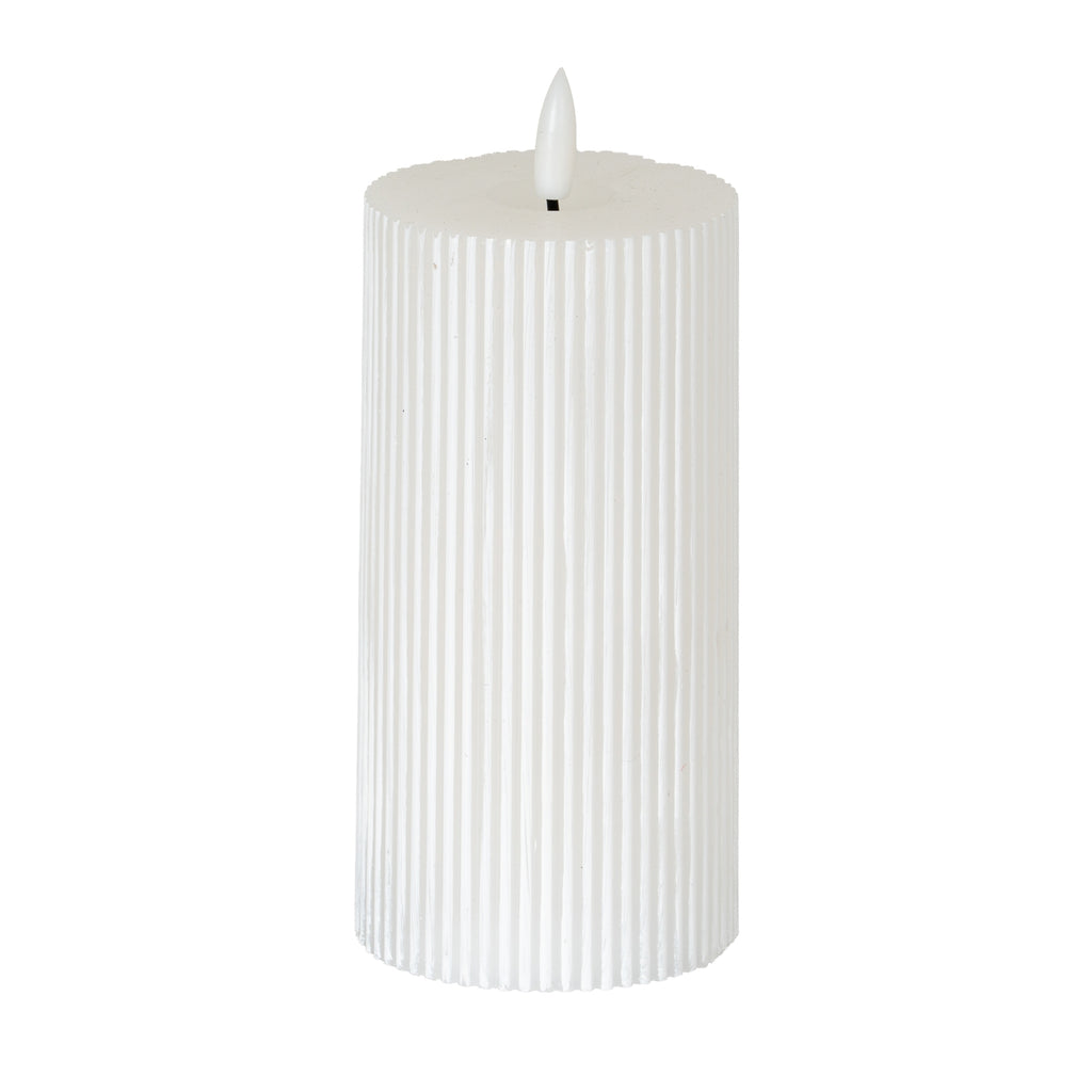 Warm-white LED pillar candle with fine vertical ribs, a shallow top recess and a white flame-shaped element against a white background.