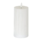 Warm-white LED pillar candle with fine vertical ribs, a shallow top recess and a white flame-shaped element against a white background.
