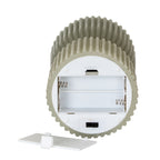 Underside of the ribbed candle showing a white housing with two empty AA-marked battery bays, a black slide switch and the detached white cover in front.