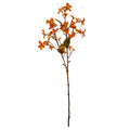Full view of an orange artificial flower spray, with branching reddish-brown stems, small blossom clusters and olive-green leaves above a long bare stem.