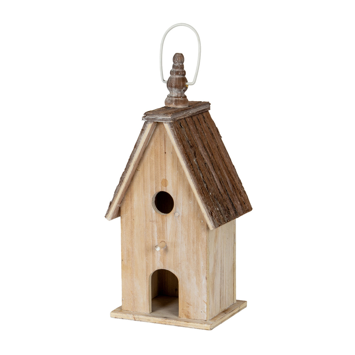Three-quarter front view of the birdhouse, showing its pale washed body, dark pitched roof, square plinth and finial beneath a pale loop.