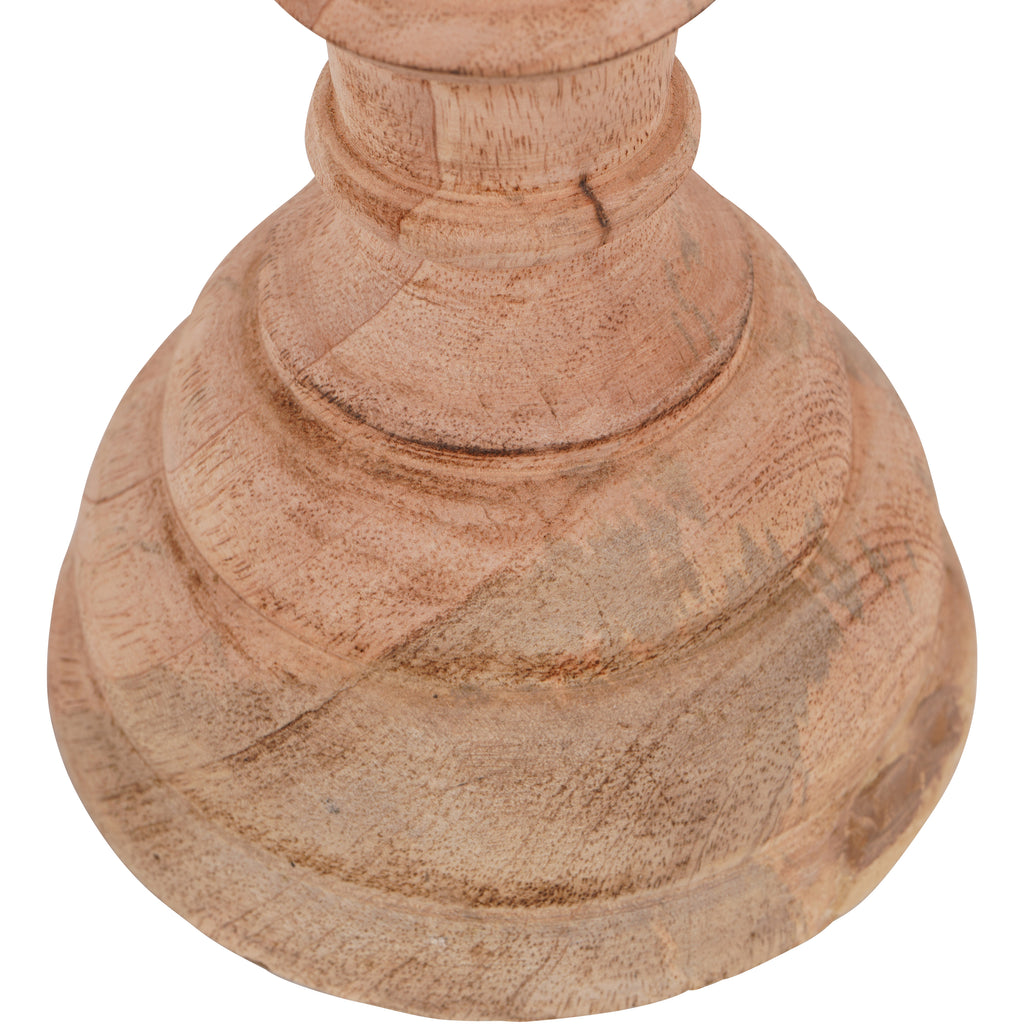 Close-up of the finial sculpture's stepped circular base, with visible wood grain and darker lines across the pale surface.