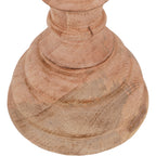 Close-up of the finial sculpture's stepped circular base, with visible wood grain and darker lines across the pale surface.