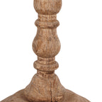 Close-up of the finial's narrow upper sections, with carved rings, rounded curves and textured brown wood grain.