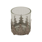 Close-up of the candle holder showing the open circular rim, layered fir-tree silhouettes and mottled finish on the star-topped cut-outs.