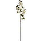 Full view of an artificial flowering branch with a long brown stem, white flower clusters and dark green oval leaves against white.