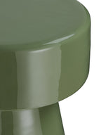 Close-up of the green tabletop's rounded edge and deep rim, with reflections in the glossy finish.
