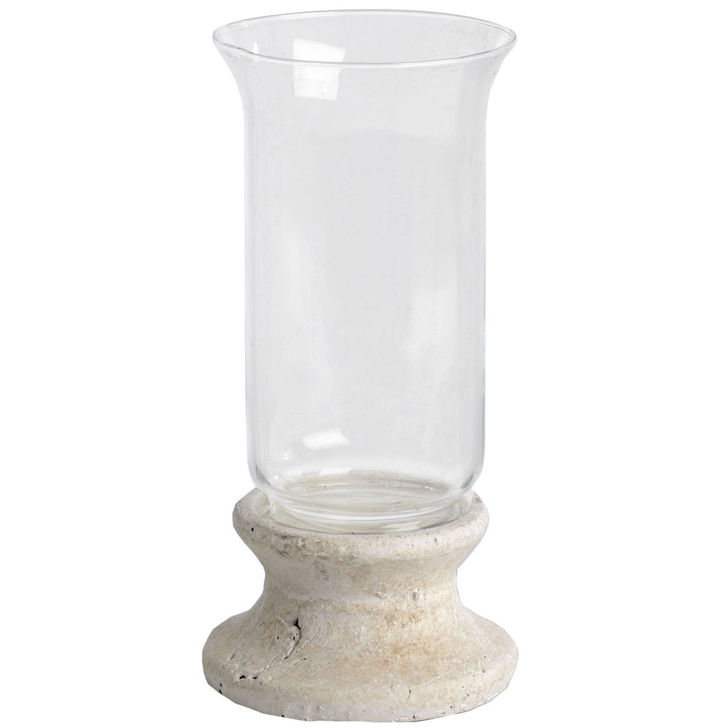 Candle lantern on a white background, with an empty clear flared sleeve above a mottled cream-grey pedestal and broad circular foot.