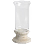 Candle lantern on a white background, with an empty clear flared sleeve above a mottled cream-grey pedestal and broad circular foot.