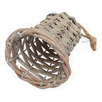 Angled close-up looking into the open underside of the woven bell, showing its curved flared rim, brown-grey strands and silver-coloured frame.