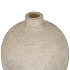 Close view from above of the vase's circular opening, short neck and textured cream shoulders with dark markings.