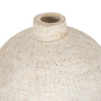 Close-up from above of the vase's circular opening, short neck and curved shoulders with dark surface markings.