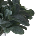 Close-up of overlapping sage-green artificial leaves showing their fuzzy flocked surfaces, leaf veins and gently scalloped edges.