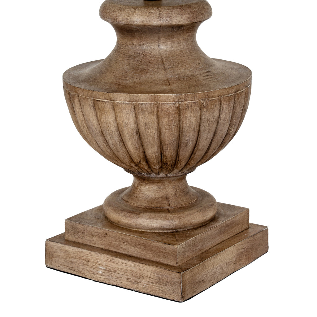 Close-up of the lamp's brown fluted bowl, curved foot and stepped square plinth, showing darker recesses and grain-like surface markings.