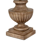 Close-up of the lamp's brown fluted bowl, curved foot and stepped square plinth, showing darker recesses and grain-like surface markings.
