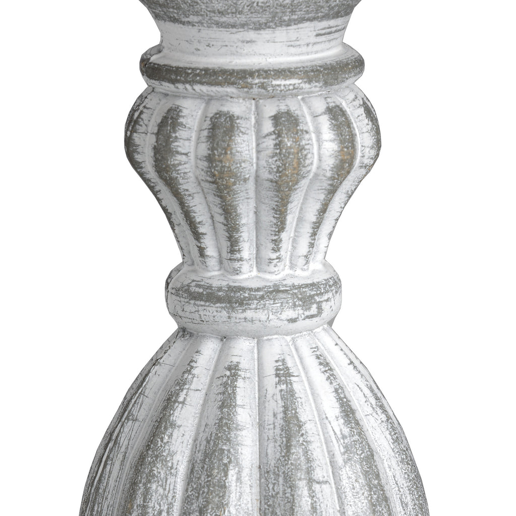 Close-up of the lamp's rounded fluted sections and ringed collars, showing pale surface markings over darker grey areas.