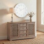 Fluted Collar Table Lamp on a pale wooden sideboard beneath a large wall clock, with stacked books and a vase of foliage beside it.