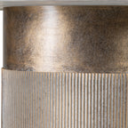 Close-up beneath the marble top, showing the mottled gold finish on the smooth upper band and fine fluting below.