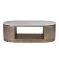Front view of an oval coffee table with a pale veined marble top, gold-toned fluted curved ends and an open lower shelf on a white background.