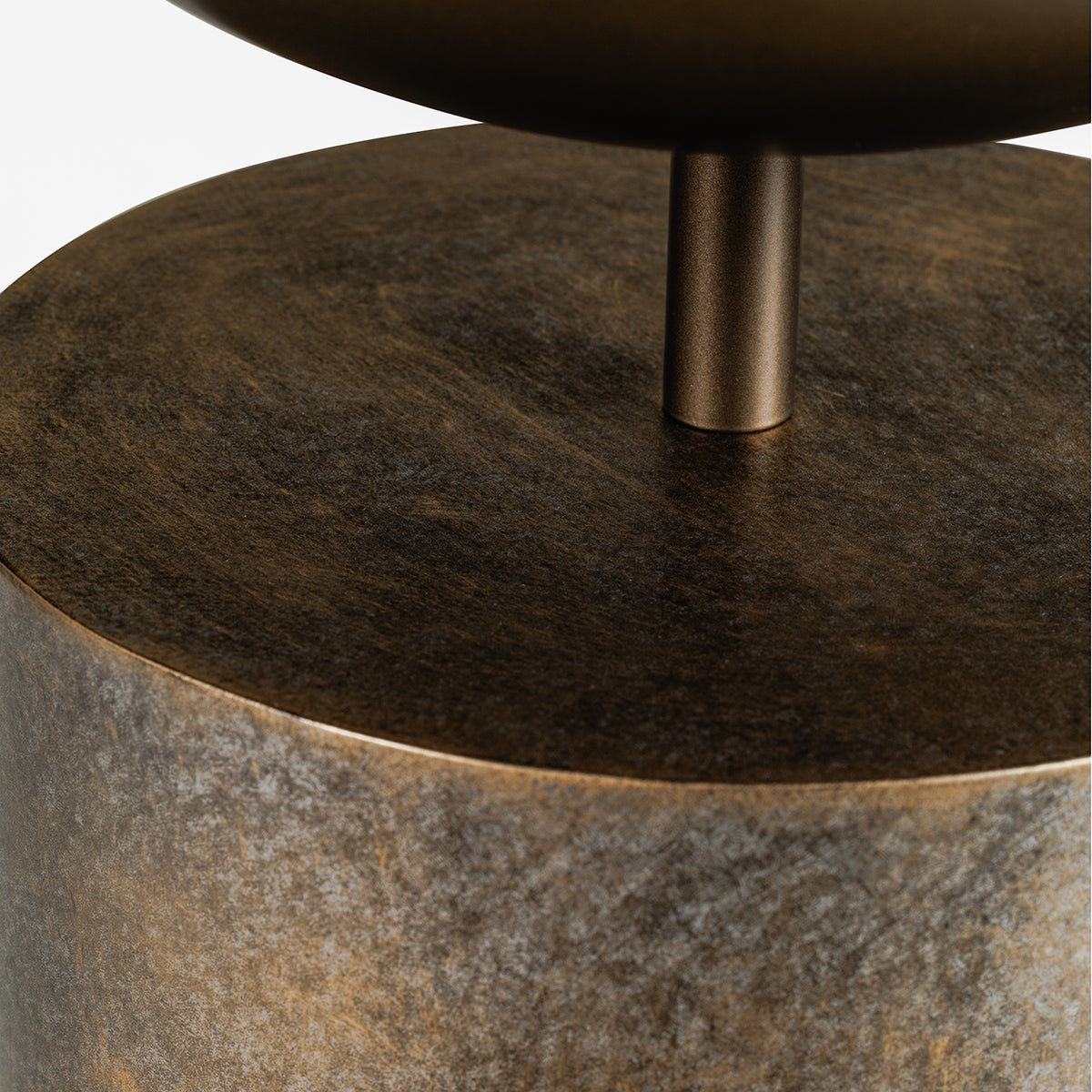 Close-up beneath the planting bowl showing its short metal stem and the mottled gold surface at the top of the pedestal.