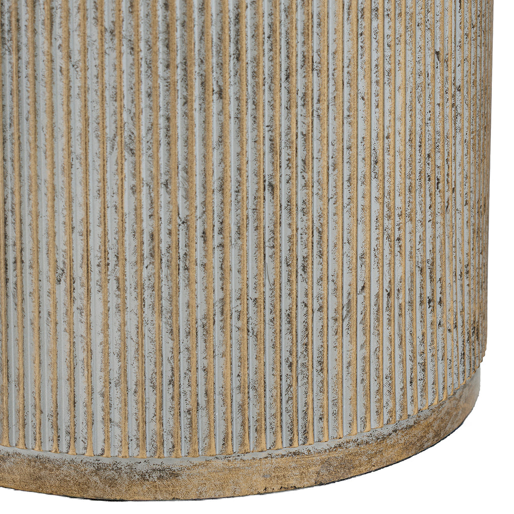 Detail of closely spaced vertical fluting on the gold pedestal, with pale recesses, mottled colouring and a narrow base rim.