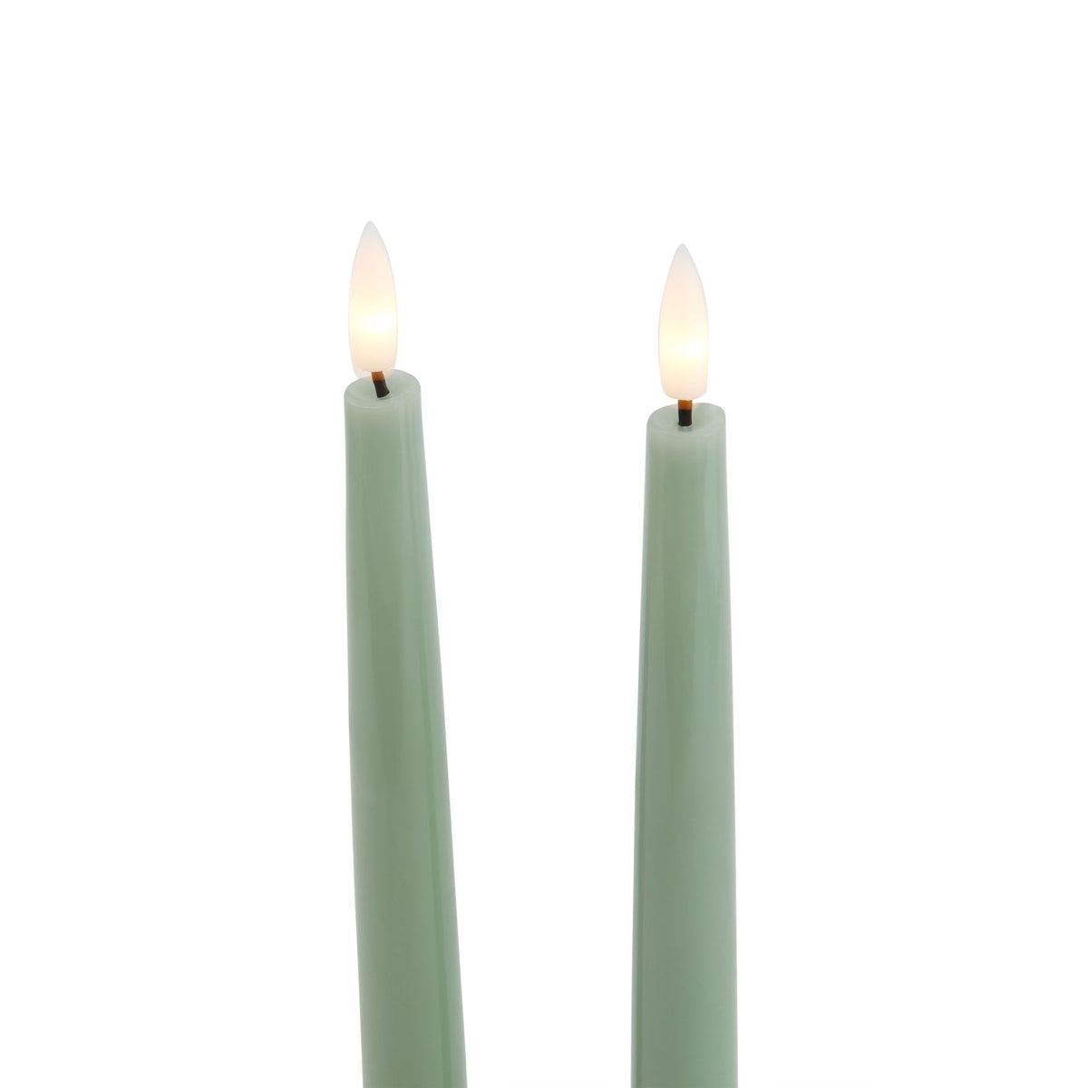 Close-up of the green candle tops, showing pale yellow glowing-looking flame inserts on short dark stems.